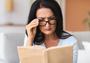 woman trying to read with reading glasses